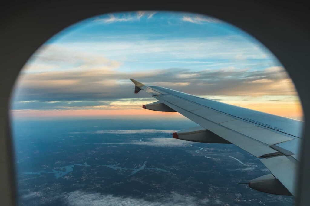 Aerial view from airplane window seat over wing
