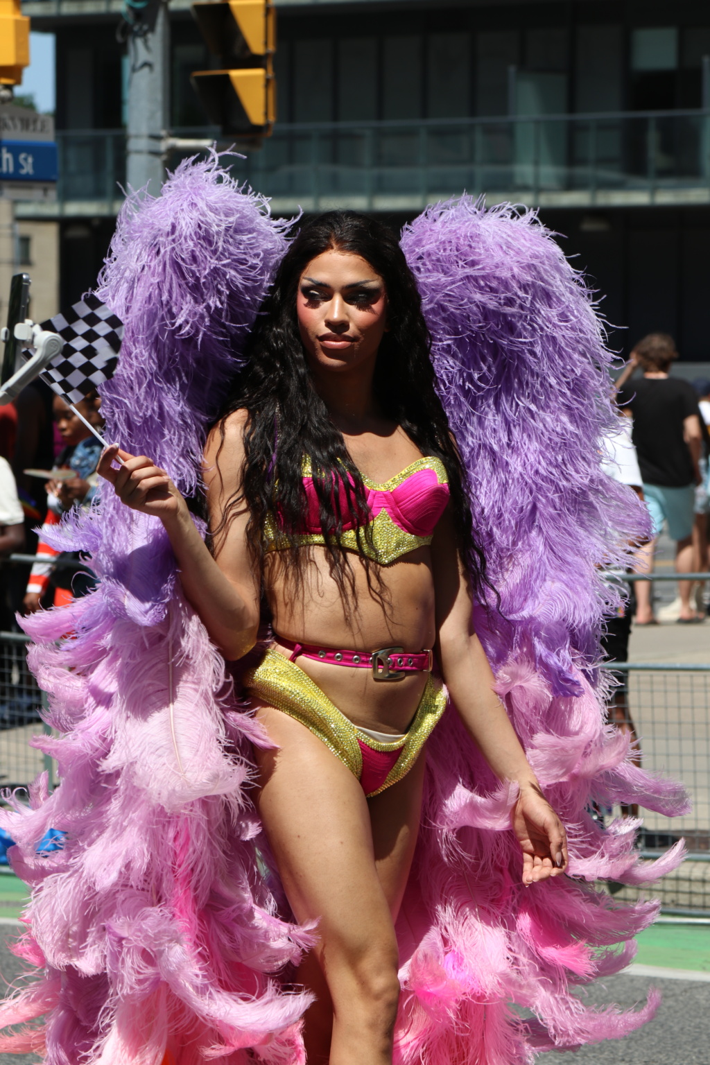 drag performer in feathers and show wear at toronto's 2025 pride parade