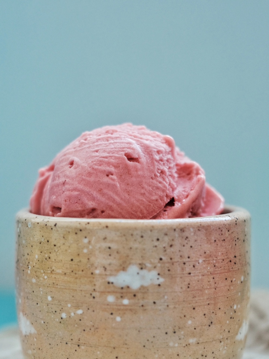 a close up of a bowl of strawberry gelato