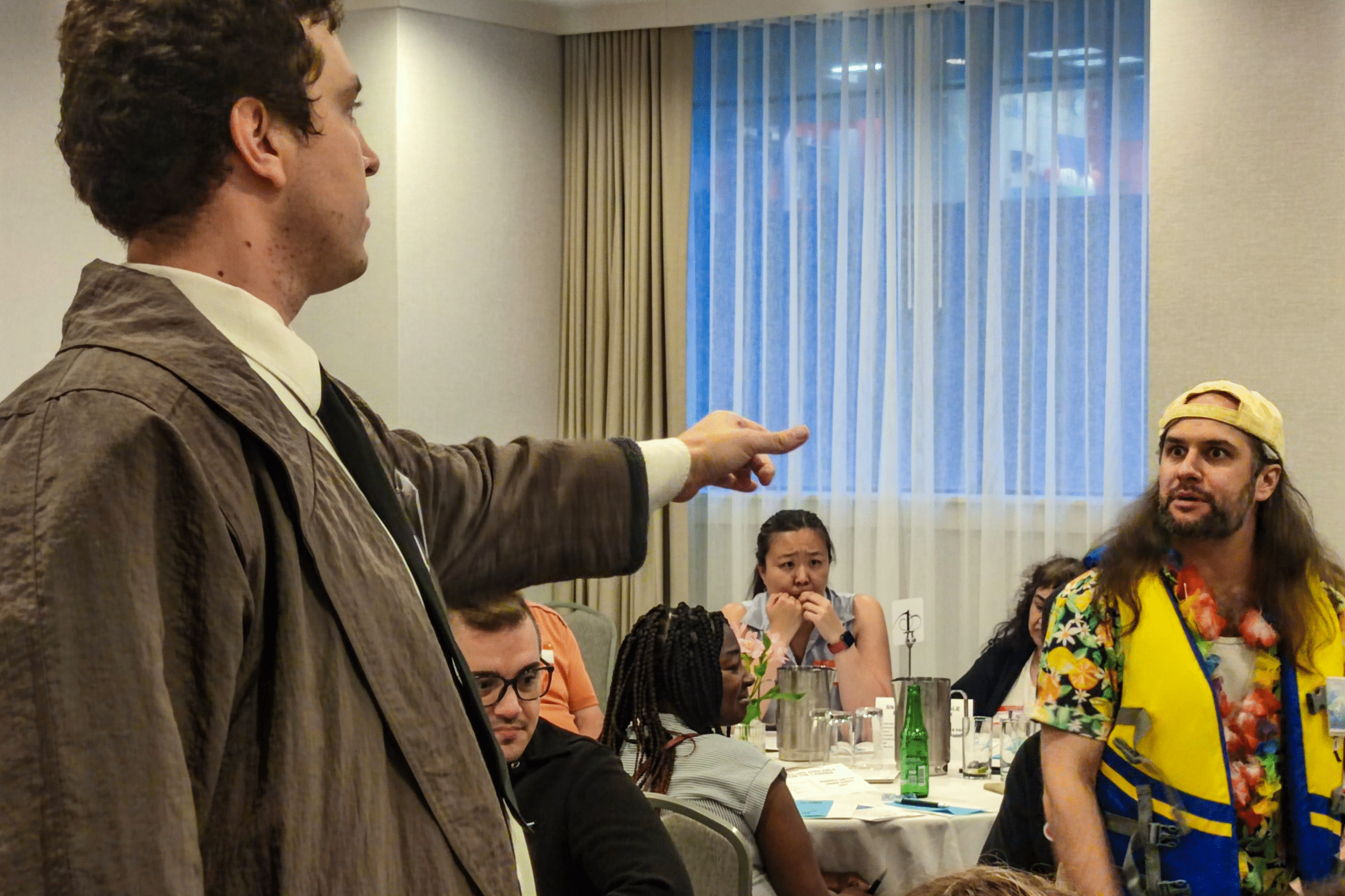a murder mystery character pointing at a suspect.